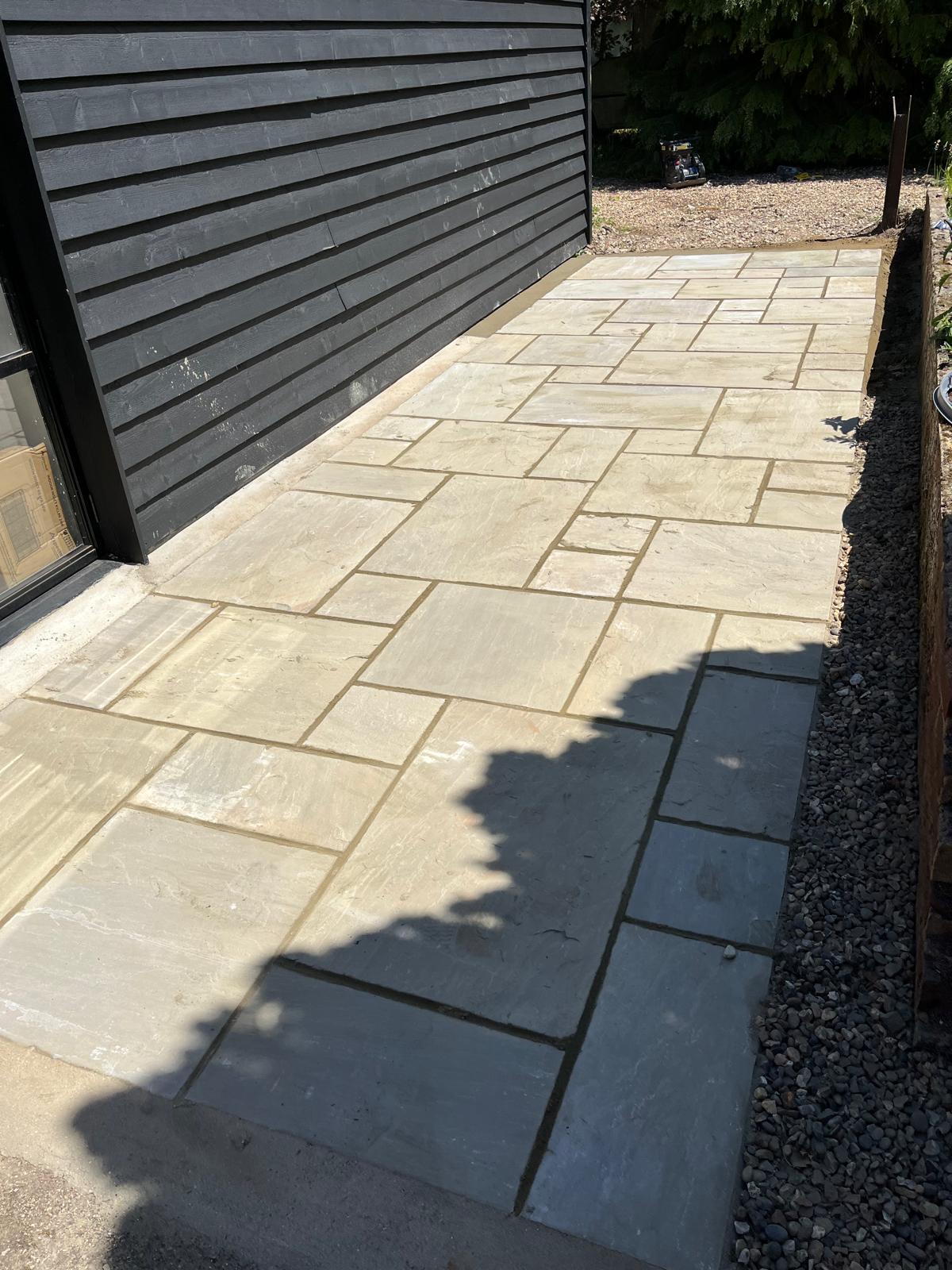 Light stone path beside garden building