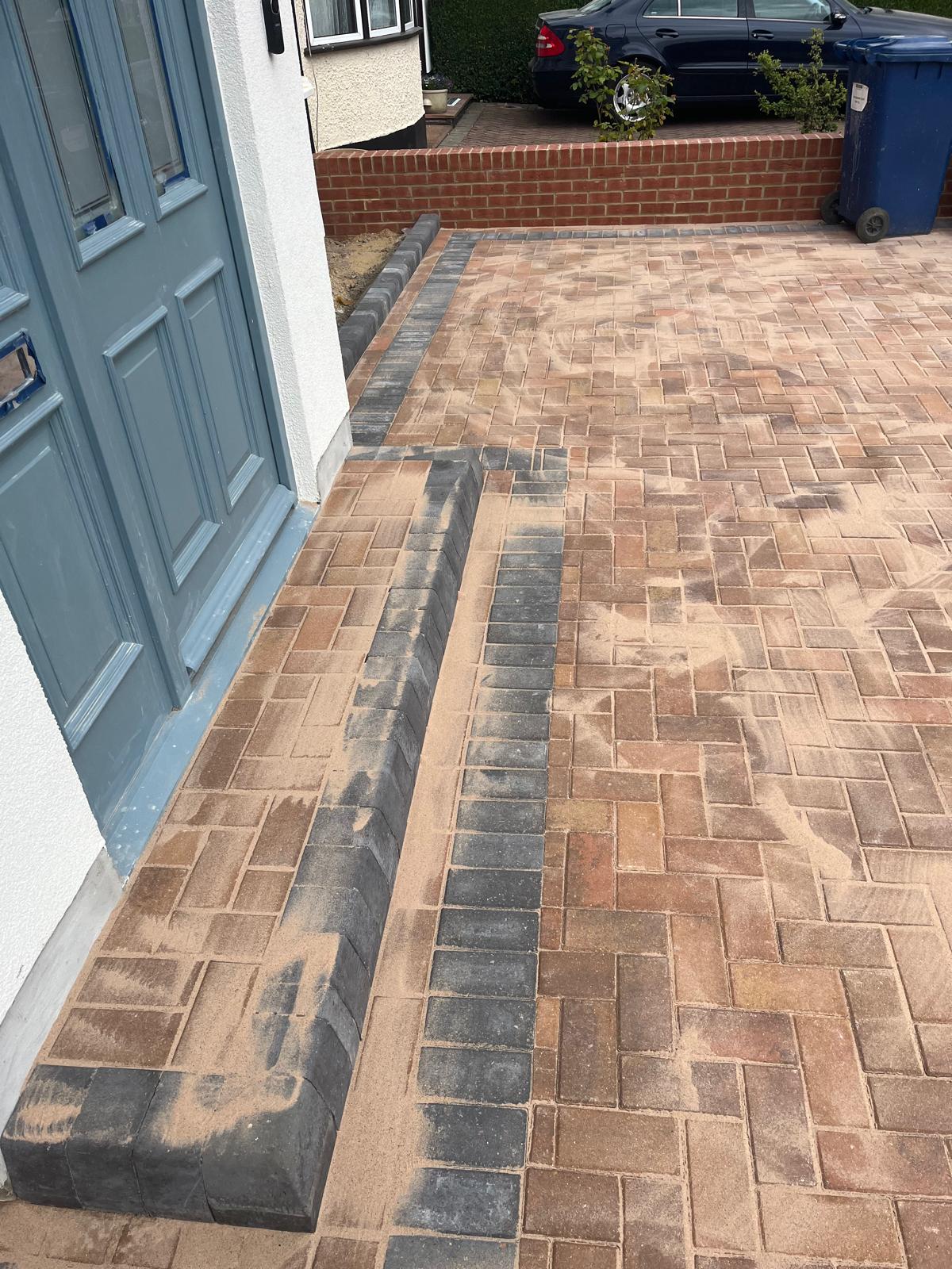 Block-paved entrance with dark border and drainage