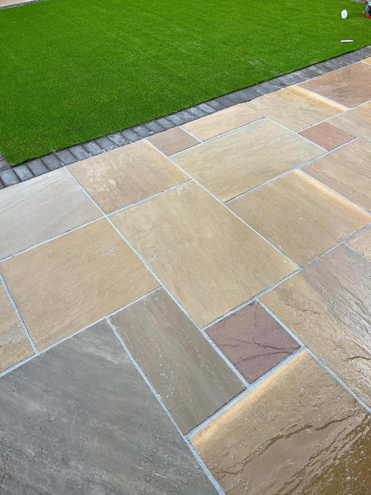 Close detail of light natural stone paving and edging