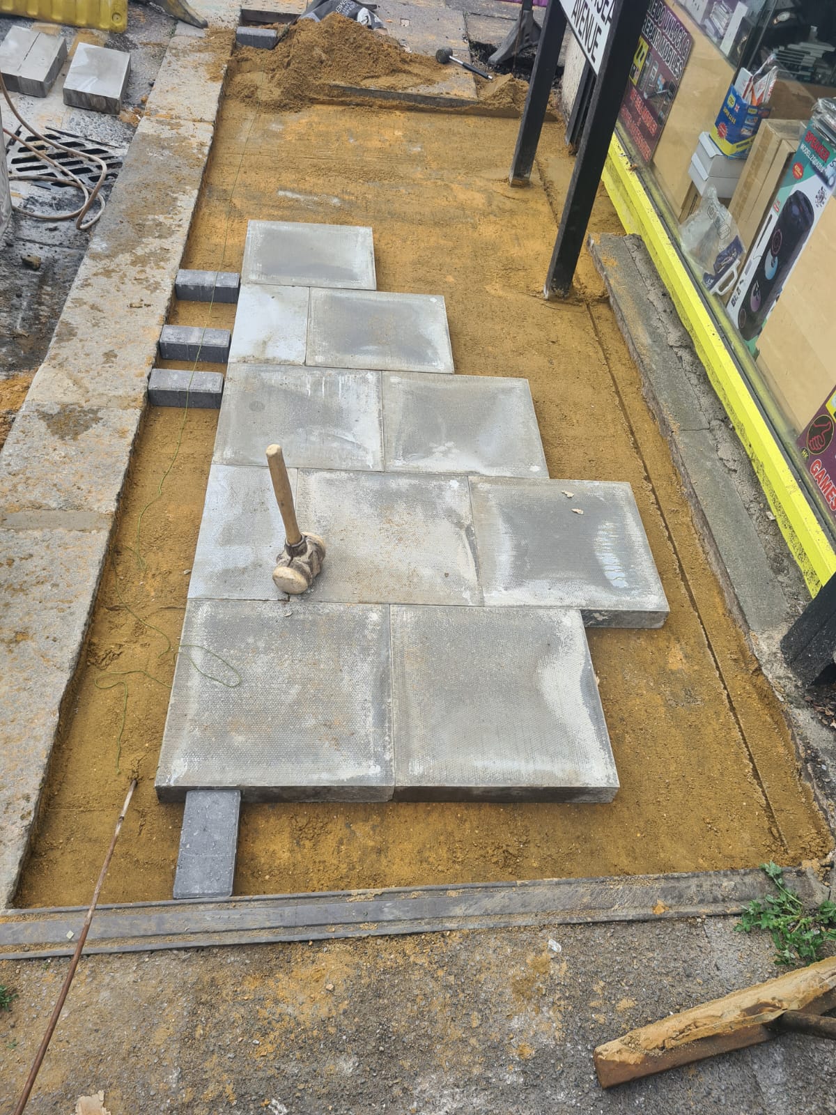 Natural stone paving bed and partially laid slabs