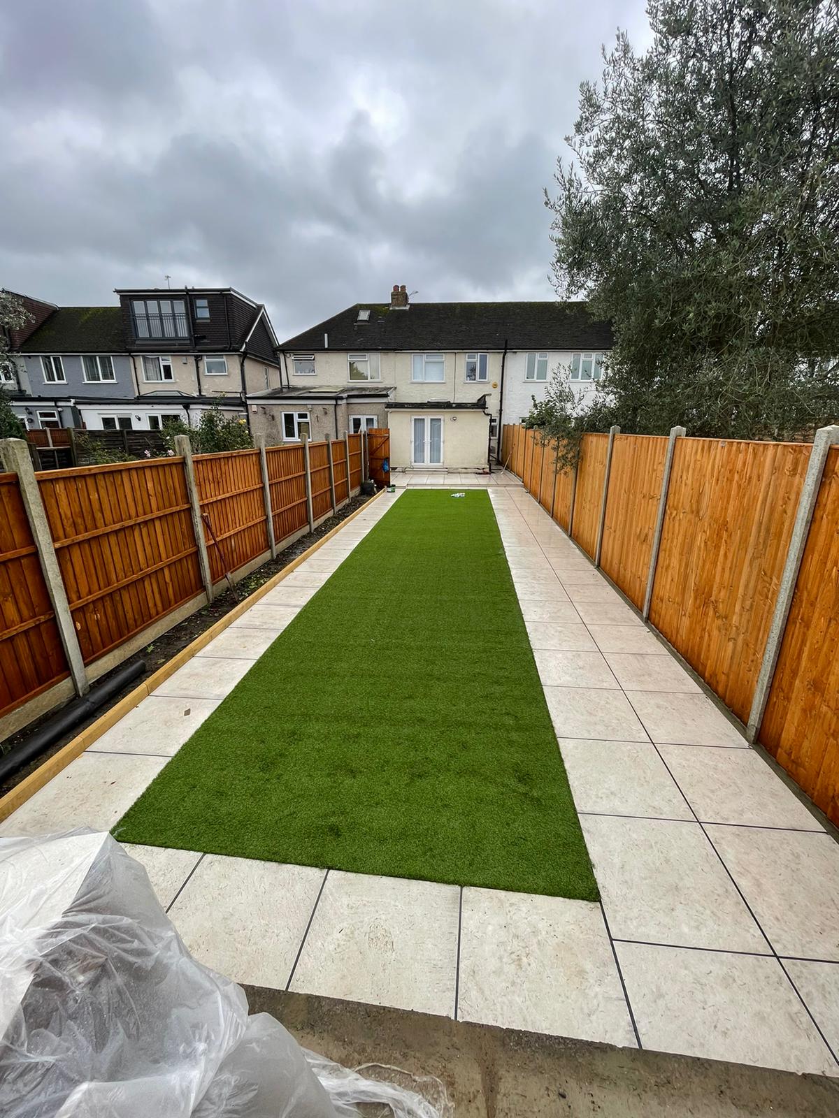 Completed garden lawn with wide paved border